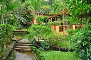 a garden with stairs leading to a house at Bopath Falls Rock Chalets in Agalawatta