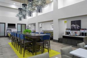 a dining room with a table and chairs at Hampton Inn & Suites Irvine/Orange County Airport in Irvine