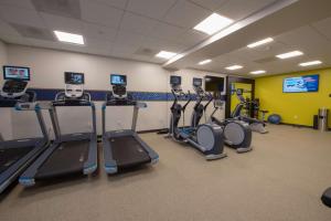 a gym with several tread machines in a room at Hampton Inn & Suites Irvine/Orange County Airport in Irvine