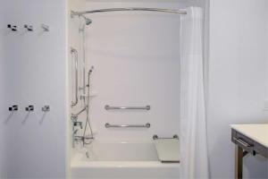 a white bathroom with a shower and a tub at Hampton Inn & Suites Irvine/Orange County Airport in Irvine