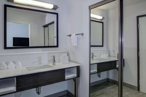 a bathroom with two sinks and a mirror at Hampton Inn & Suites Irvine/Orange County Airport in Irvine