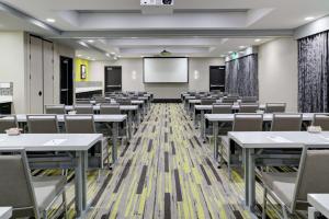 a classroom with tables and chairs and a screen at Hampton Inn & Suites Irvine/Orange County Airport in Irvine