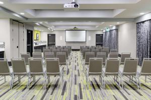 a conference room with chairs and a projection screen at Hampton Inn & Suites Irvine/Orange County Airport in Irvine +25 photos