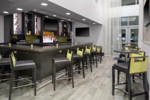 a bar with chairs and tables in a restaurant at Hampton Inn & Suites Irvine/Orange County Airport in Irvine