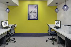 an office with two desks and two laptops on them at Hampton Inn & Suites Irvine/Orange County Airport in Irvine
