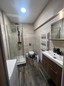 La salle de bains est pourvue d'une douche, d'un lavabo et de toilettes. dans l'établissement Maison DE LUR, à Périgueux