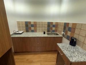 a kitchen with a sink and a counter top at OLIVIA HOME STAY in Dehradun