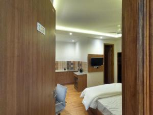 a hotel room with a bed and a bathroom at OLIVIA HOME STAY in Dehradun