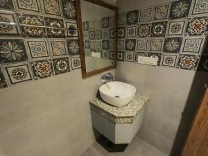 a bathroom with a sink and a mirror at OLIVIA HOME STAY in Dehradun