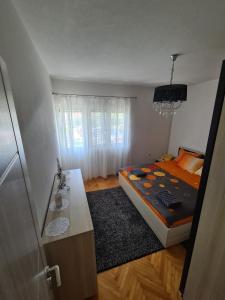 a bedroom with a bed and a table in it at Kuća Moric in Tivat