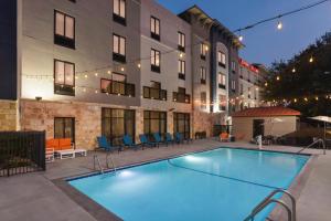 a swimming pool in front of a building at Hampton Inn & Suites San Marcos in San Marcos