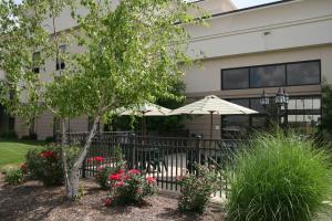 a fence with an umbrella in front of a building at Hampton Inn & Suites, Springfield SW in Springfield