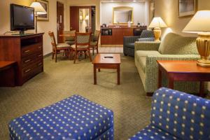a living room with couches and chairs and a television at Hampton Inn & Suites, Springfield SW in Springfield