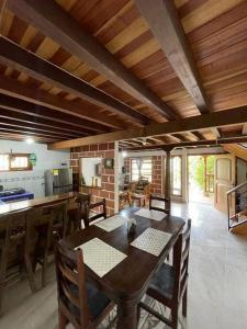 a kitchen and dining room with a wooden table and chairs at Hermosa casa finca en Medellín con jacuzzi ! in Medellín