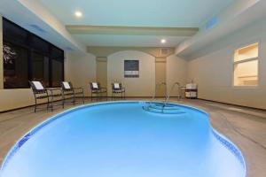 a pool in a room with chairs and a table at Hampton Inn Santa Cruz in Santa Cruz