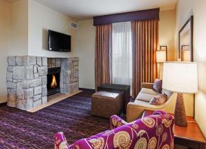 a living room with a couch and a fireplace at Homewood Suites Wichita Falls in Wichita Falls