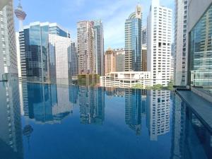 a view of a city from a swimming pool at RM218 Bukit Bintang Balcony Studio Infinity Pool in Kuala Lumpur