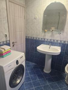 a bathroom with a washing machine and a sink at Kuća Moric in Tivat
