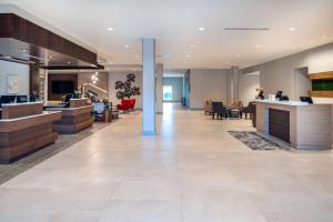 an office lobby with a reception desk and chairs at Hilton Garden Inn Brunswick in Brunswick