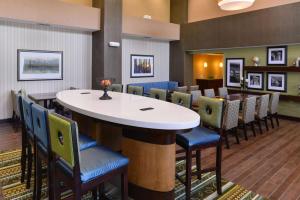 a bar in a restaurant with chairs and tables at Hampton Inn & Suites St. Louis - Edwardsville in Glen Carbon