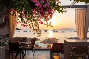 a dining room with a view of the ocean at Buganvilla-Sea front villas in Agia Pelagia