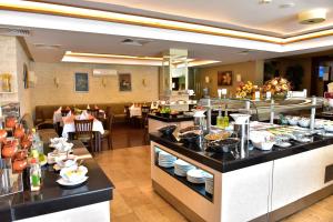 a buffet line with food on display in a restaurant at private apartment hotel Regnum Bansko in Bansko