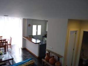a kitchen and living room with a table and a counter at EL COLLADO, Ruiloba in Sierra +36 photos