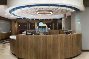 a lobby of a hospital with a reception counter at Tru by Hilton St. Charles St. Louis in St. Charles