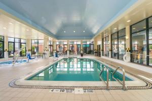 a large swimming pool in a building with a large lobby at Hilton Garden Inn Fishkill in Fishkill