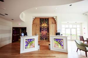 a room with two stained glass windows in front of a door at Hotel Skyler Syracuse, Tapestry Collection by Hilton in Syracuse