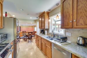 a kitchen with wooden cabinets and a dining room at Campbell Vacation Rental about 8 Mi to San Jose! in Campbell