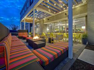 een patio met 2 banken en een vuurplaats bij Home2 Suites By Hilton Wayne, NJ in Wayne