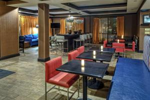 a restaurant with tables and chairs and a piano at Hampton Inn Tullahoma in Tullahoma