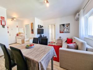 a living room with a table and a couch at Apartment Praia Rocha Seashell in Portimão