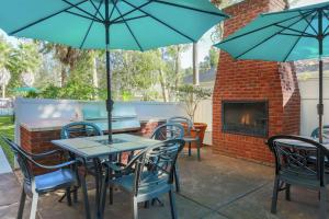 a patio with tables and chairs and a fireplace at Hampton Inn & Suites Tallahassee I-10-Thomasville Road in Tallahassee