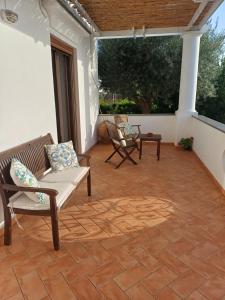 a patio with two chairs and a couch and a table at La Casa di Pitti in Anacapri