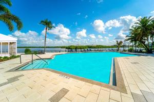 a swimming pool with a view of the water at DoubleTree by Hilton Tampa Rocky Point Waterfront in Tampa