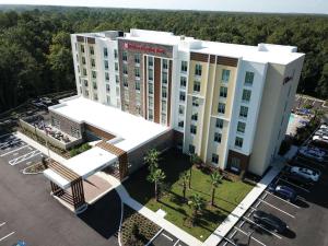 an aerial view of a hotel building with a parking lot at Hilton Garden Inn Tampa - Wesley Chapel in Wesley Chapel