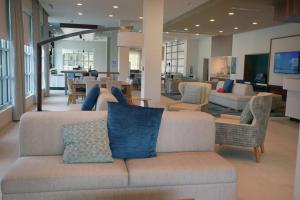 a living room with a couch and chairs at Hilton Garden Inn Tampa - Wesley Chapel in Wesley Chapel