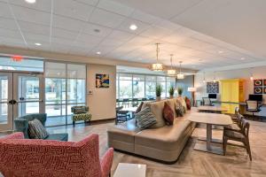 a living room with a couch and a table at Home2 Suites By Hilton Tampa USF Near Busch Gardens in Tampa