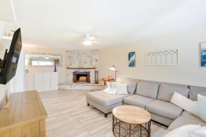 a living room with a couch and a fireplace at Solana Beach Condo with 4 Pools and Beach Access! in Solana Beach