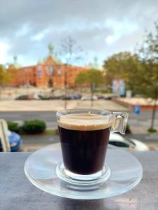 a cup of coffee sitting on a plate on a table at Lisbon`s best at Campo Pequeno in Lisbon