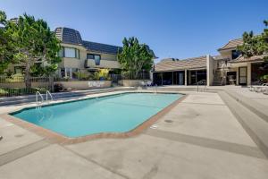 a swimming pool in front of a house at Solana Beach Condo with 4 Pools and Beach Access! in Solana Beach