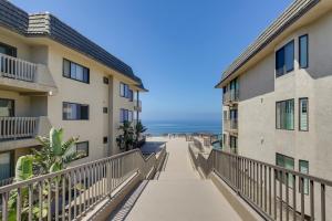 a walkway between two buildings with the ocean in the background at Solana Beach Condo with 4 Pools and Beach Access! in Solana Beach