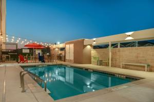a swimming pool in a hotel at night at Home2 Suites By Hilton Temple in Temple