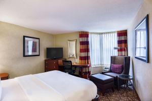a hotel room with a bed and a chair and a desk at DoubleTree by Hilton Johnson City in Johnson City