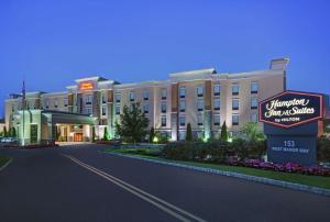 a rendering of a hotel with a sign in front of it at Hampton Inn and Suites Robbinsville in Robbinsville