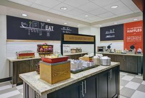 a restaurant with a counter with food on it at Hampton Inn and Suites Robbinsville in Robbinsville