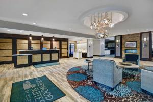a hotel lobby with a bar and a dining area at Homewood Suites by Hilton Hamilton, NJ in Hamilton