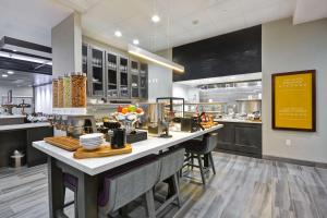 a large kitchen with a large island in the middle at Hilton Garden Inn Tulsa-Broken Arrow, OK in Broken Arrow